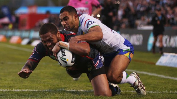 Dominant: Manu Vatuvei of the Warriors dives over for a try against the Raiders on Saturday.