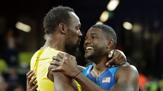 Gold medal winner Justin Gatlin embraces Usain Bolt.