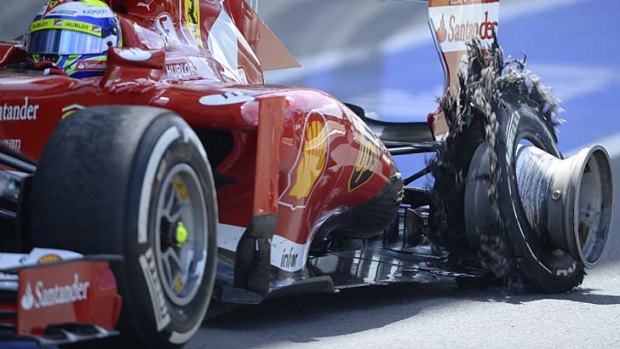 Contemplating a boycott: Ferrari'sFelipe Massa enters the pit with a blown tyre.