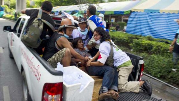 A nurse attends to an injured Red Shirt protester on the back of a truck inside the protesters' camp.