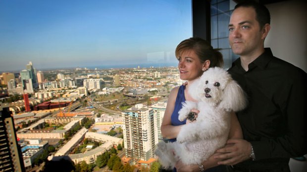 Twelve-year-old bichon frise Kira enjoys the panoramic view of Melbourne from high up in the Eureka Tower with her owners Louise Schaper and Ryan Turan.