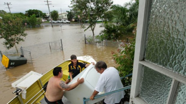 From deeper water to higher ground ... residents leave Depot Hill in Rockhampton.
