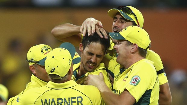 Influential: Mitchell Johnson is mobbed.