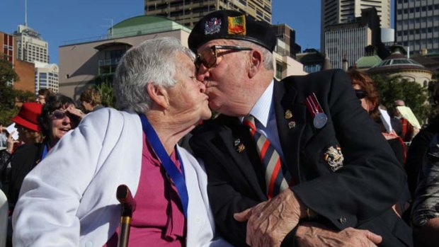 Recognition medallion ... recipient Dorothy Pollard recieves a kiss from her husband Doug Pollard.