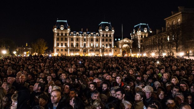 People gather outside of Notre Dame Cathedral ahead of a ceremony to the victims terrorist attacks on November 15, 2015 in Paris.