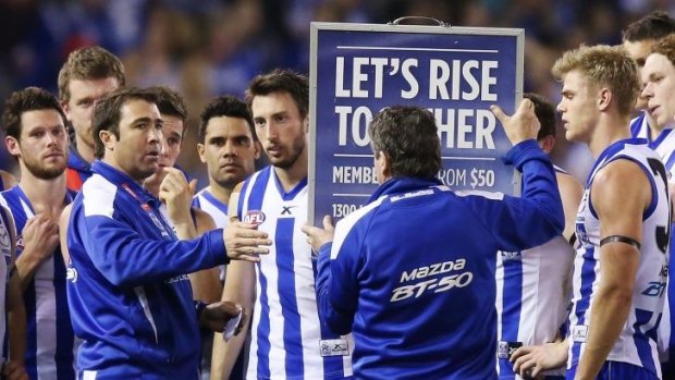 Game plan: North Melbourne coach Brad Scott gives his Kangaroos instructions on how to stay on top of Melbourne. 
