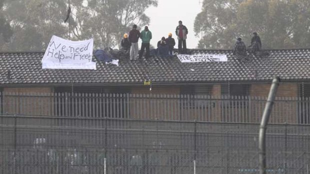 Detainees protest on the roof of Villawood detention centre this morning.