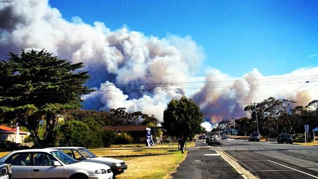 Smoke climbs from a fire burning just kilometres from homes at Bicheno, 150km north-east of Hobart.