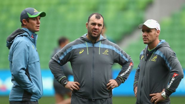 Different paths to the top: Michael Cheika (centre) with assistant coaches Stephen Larkham (left) and Nathan Grey (right).