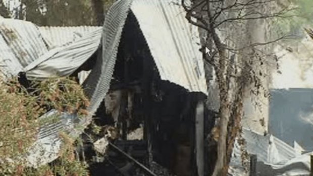 The smouldering remains of the Carabooda house fire, which killed two girls.