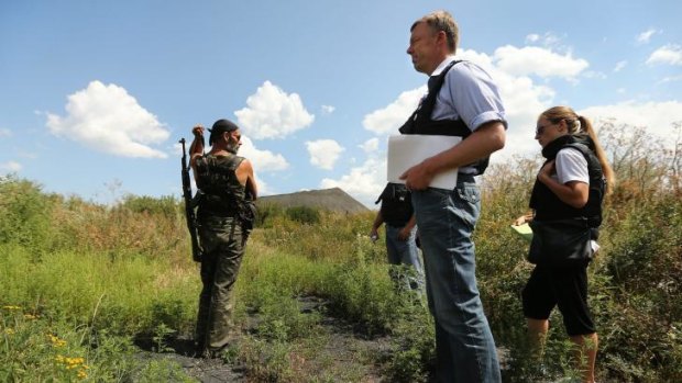 Deputy head of the OSCE mission, Alexander Hug, with pro-Russian rebel Yuri at the crash site.