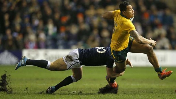 Israel Folau is tackled by Scotland's Duncan Weir last weekend.