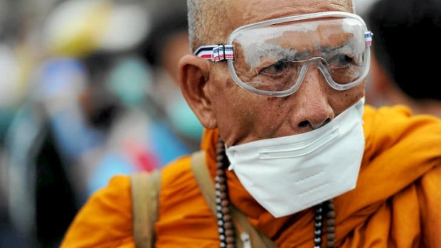 Protests &#8230; a Buddhist monk wears a mask as a protection against tear gas.