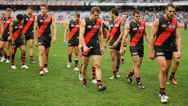 Behind the eight-ball: Embarrassed by Carlton, the crestfallen Bombers trudge off the MCG on Saturday.