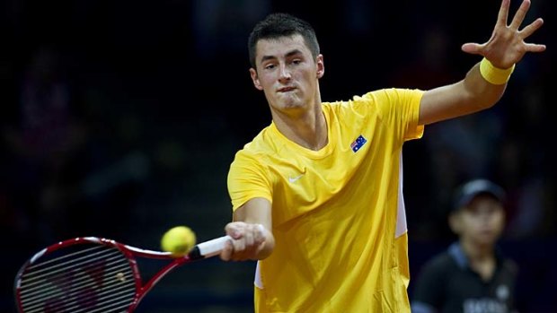 Bernard Tomic plays a forehand during his match against Poland's Lukasz Kubot.