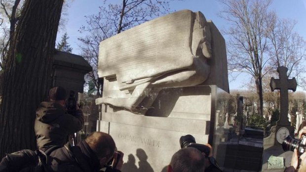The newly renovated tomb of Oscar Wilde. The tomb was previously covered by lipstick kisses, hearts and red graffiti containing expressions of love.
