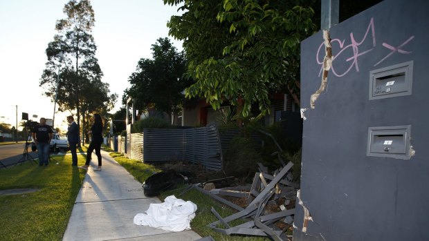 The remains of a fence that was hit by a car after a shooting in Matthew Street, Heckenberg.