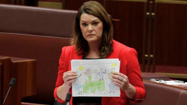Pictures of despair &#8230; Greens senator Sarah Hanson-Young with drawings done by some of the 38 children held with their families at Papua New Guinea's Manus Island processing centre.