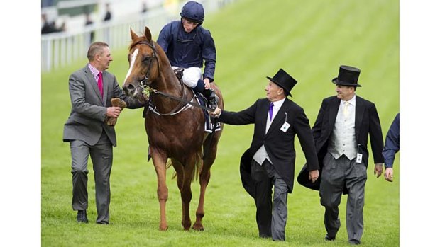 Derby delight: Ryan Moore returns Ruler Of The World to the winner's stall after the Epsom Derby.