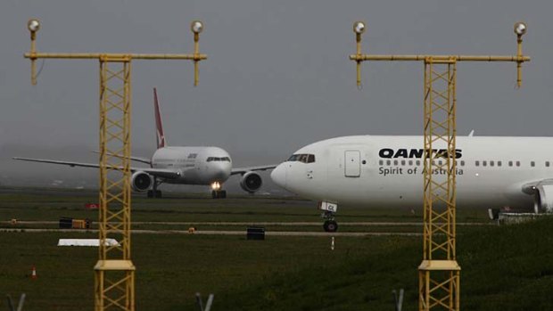 Planes queue for take-off at Sydney Airport yesterday.