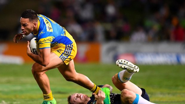 Slippery Eel: Parramatta playmaker Corey Norman skips out of Michael Morgan's tackle on Friday night.