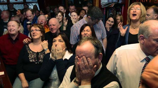Customers react as they watch Andy Murray play Novak Djokovic at the Dunblane Hotel.