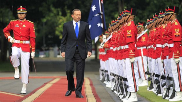 PM Tony Abbott, on his first overseas visit as Prime Minister, inspects the honour guard in Jakarta, Indonesia.