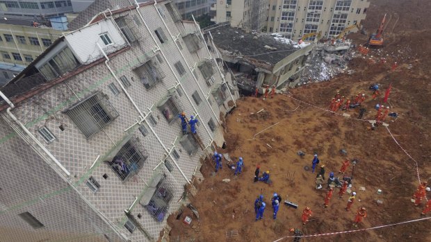 Rescue workers search for survivors in the aftermath of the landslide in Shenzhen.