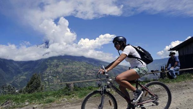 Forces of nature ... cycling while the Tungurahua volcano erupts.