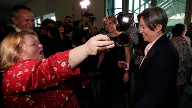 Magda Szubanski embraces Senator Penny Wong after the vote on the Marriage Amendment Bill at Parliament House.