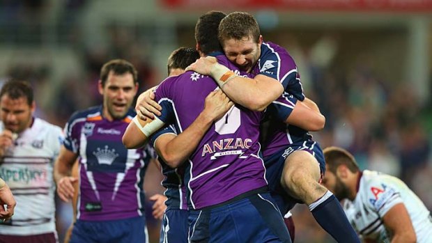 Celebrate ... the Storm players congratulate Jesse Bromwich on his try.