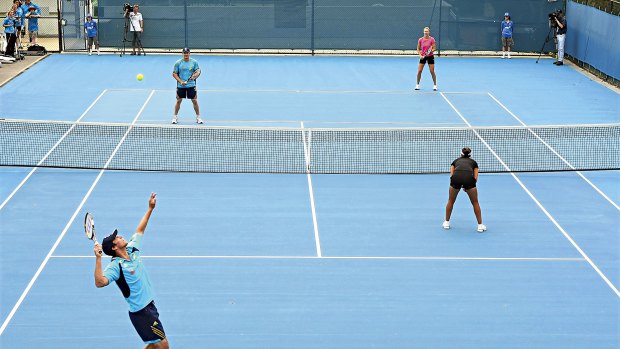 Getting into the spirit ... Test duo Mitchell Johnson and Shane Watson turned out for a mixed doubles match with Alicia Molik and India's Sania Mirza in Hobart yesterday.