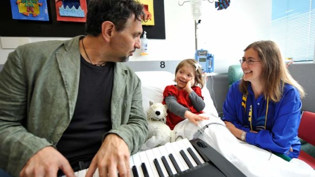 Dr Catherine Crock, pictured above with musician Joe Chindamo and patient Holly Richards, created the Hush music collection to calm young patients and their families.