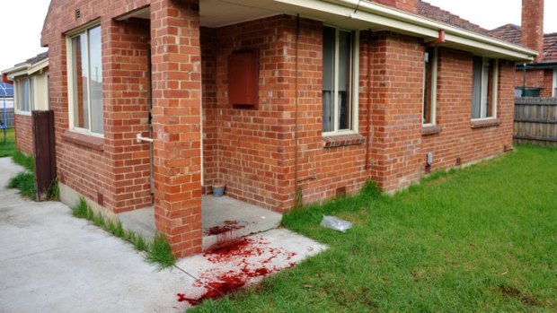 The scene ... Blood covers the steps and lawn for the house in Wright Street, Reservoir.