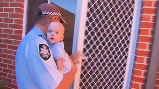 Police return the baby to its mother. <em> Photo: Courtesy Nine News </em>