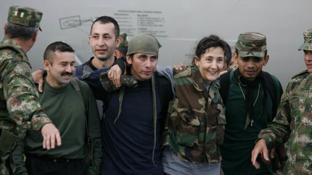 Struggle ... Ingrid Betancourt smiles as she walks with other released hostages in Bogota in 2008.