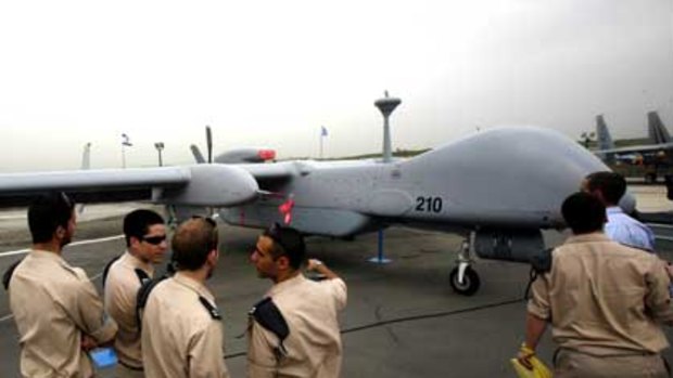 Israeli soldiers look at an IAI Eitan, also known as the Heron TP, surveillance unmanned air vehicle.