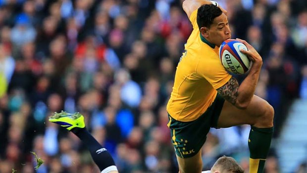 Israel Folau of Australia skips out of tackle from Chris Ashton in the lead up to Matt Toomua's try.