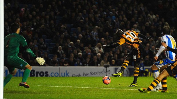 Hull City's Yannick Sagbo scores late against Brighton & Hove Albion.
