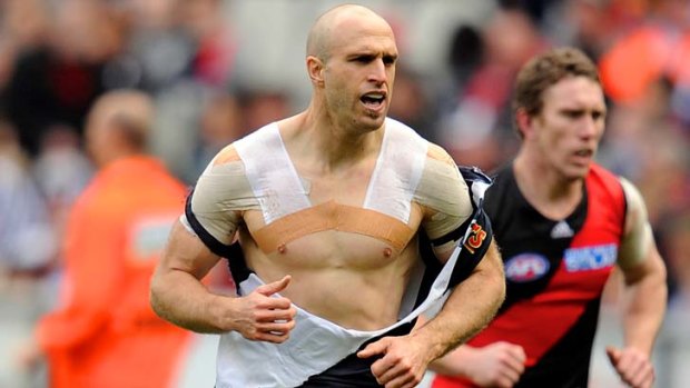 Carlton's Chris Judd comes off with a torn jumper.