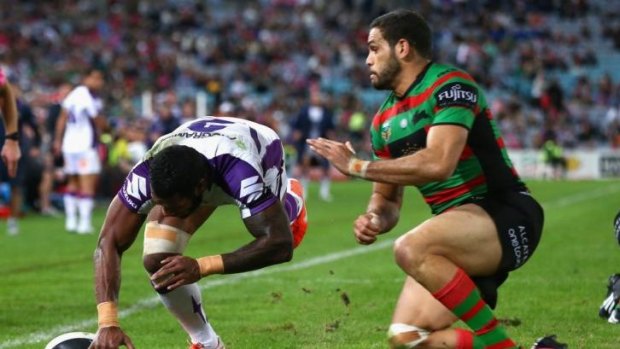 Try time: Souths star Greg Inglis is unable to stop Sisa Waqa scoring for the Storm.