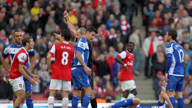 You're off ... Martin Atkinson shows Jack Wilshere the red card.