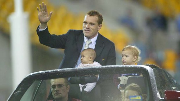 Justin Leppitsch does a lap of honour after retiring in June 2006.