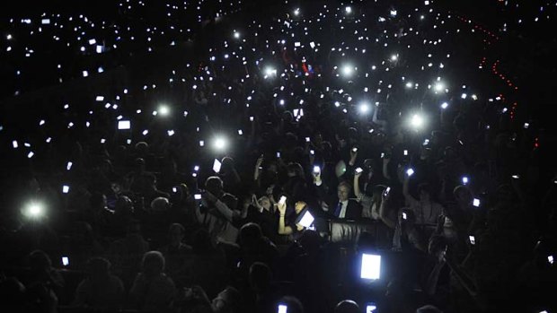 Phones and tablets are held aloft to salute the father of the web, Sir Tim Berners-Lee, at a conference in Spain.