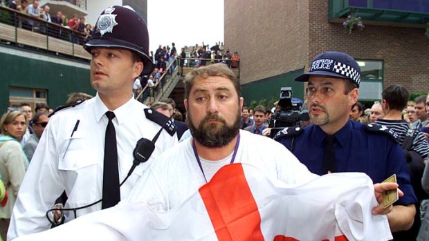 Damir Dokic, the father of Australian tennis player Jelena Dokic, is led away by police after becoming involved in a disturbance at Wimbledon, on June 29, 2000.