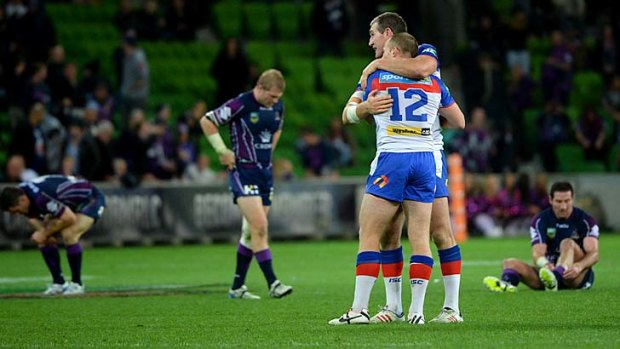 All over: Newcastle players celebrate their upset victory over Melbourne Storm at AAMI Park on Saturday night.