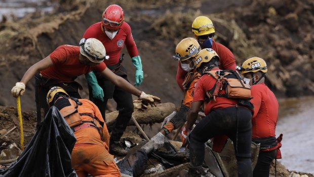 Firefighters pull a body from the mud days after the Vale mining company's dam collapsed in Brumadinho, Brazil. 