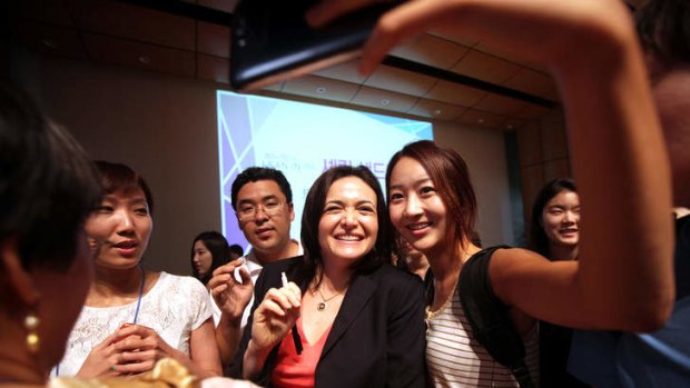 Missed doomed flight ... Sheryl Sandberg, chief operating officer of Facebook, poses with students for photographs after her speech at Yonsei University in Seoul.