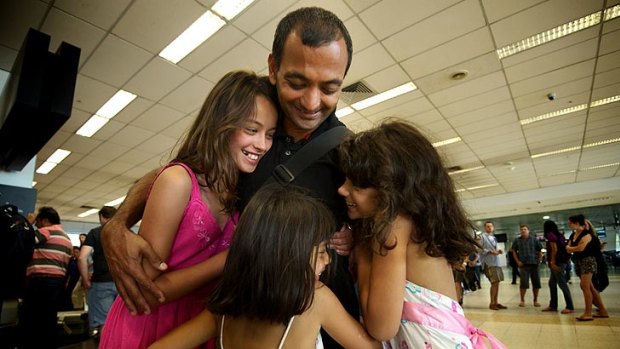 Ravi Hattarki is welcomed home from Japan by daughters Anita, Maya and Kira.