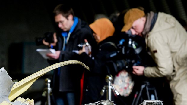 Members of the media view the wreckage of the Malaysia Airlines Flight MH17 in a hangar on  Gilze-Rijen airbase in the Netherlands. The first of around 500 relatives of those killed in the shooting down of MH17 have visited the wreckage.